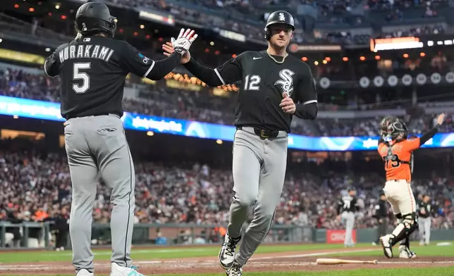 Chicago White Sox's Munetaka Murakami (5) and Colson Montgomery (12) celebrate after both scored on Andrew Benintendi's two-run double during the fourth inning of a baseball game against the San Francisco Giants Friday, May 22, 2026, in San Francisco. (AP Photo/Jeff Chiu)