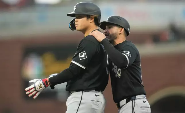 Chicago White Sox's Munetaka Murakami, left, stands at first base with first base coach Jose Leger after Murakami was hit by a pitch during the fourth inning of a baseball game against the San Francisco Giants Friday, May 22, 2026, in San Francisco. (AP Photo/Jeff Chiu)