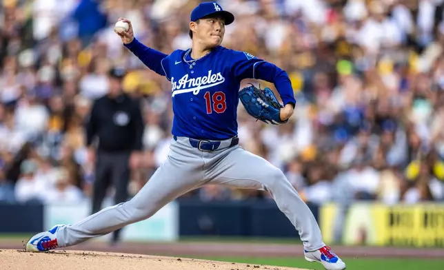 Los Angeles Dodgers starting pitcher Yoshinobu Yamamoto throws to a San Diego Padres batter in the first inning of a baseball game, Monday, May 18, 2026, in San Diego. (AP Photo/Tony Ding)