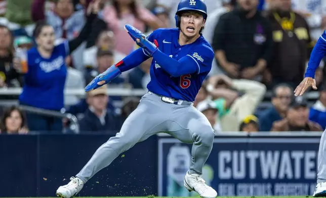 Los Angeles Dodgers' Hyeseong Kim reaches third base safely on a San Diego Padres throwing error in the sixth inning of a baseball game, Monday, May 18, 2026, in San Diego. (AP Photo/Tony Ding)