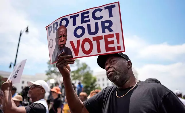 Aaron McGuire sings a spirtual song during a voting rally, Saturday, May 16, 2026, in Montgomery, Ala. (AP Photo/Mike Stewart)