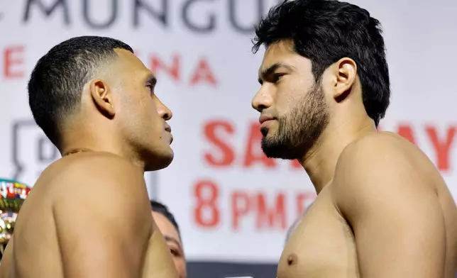 David Benavidez, left, faces off with WBA/WBO cruiserweight champion Gilberto Ramirez during a ceremonial weigh-in at MGM Grand Garden Arena, Friday, May 1, 2026, in Las Vegas. (Steve Marcus/Las Vegas Sun via AP)