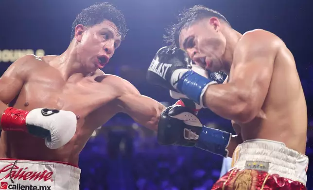 Jaime Munguia punches Armando Resendiz in a super middleweight championship boxing match Saturday, May 2, 2026, in Las Vegas. (AP Photo/Ian Maule)