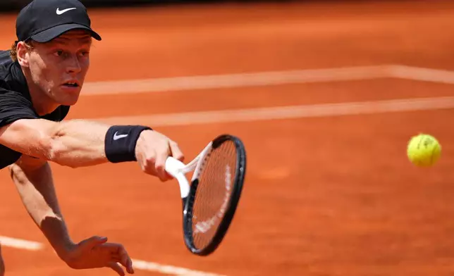 Italy's Jannik Sinner returns the ball to Andrey Rublev, during their match at the Italian Open tennis tournament in Rome, Thursday, May 14, 2026. (AP Photo/Andrew Medichini)
