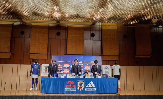 Masakuni Yamamoto, left, national team director, Hajime Moriyasu, center, head coach of Japan's national soccer team, and Tsuneyasu Miyamoto, right, president of the Japan Football Association, prepare to attend a news conference announcing Japan's squad for the 2026 FIFA World Cup Friday, May 15, 2026, in Tokyo. (AP Photo/Eugene Hoshiko)