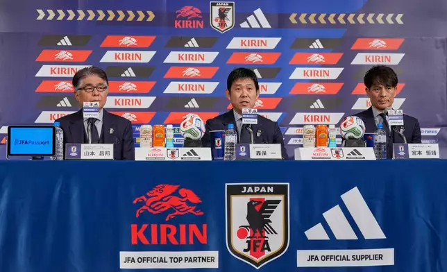 Hajime Moriyasu, center, head coach of Japan's national soccer team, accompanying Masakuni Yamamoto, left, national team director, and Tsuneyasu Miyamoto, right, president of the Japan Football Association, announces Japan's squad for the 2026 FIFA World Cup during a news conference Friday, May 15, 2026, in Tokyo. (AP Photo/Eugene Hoshiko)