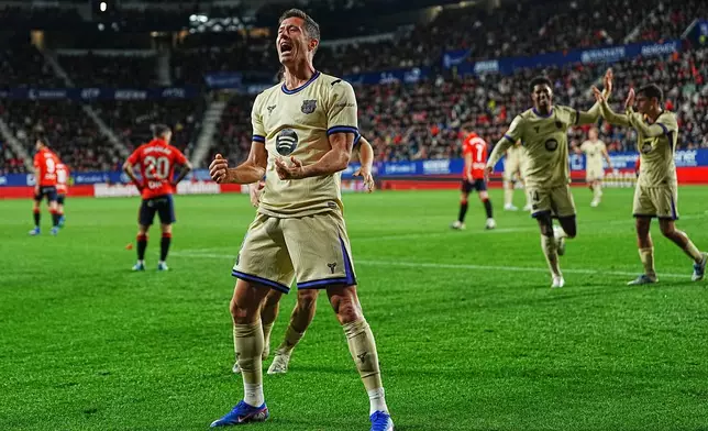 Barcelona's Robert Lewandowski celebrates after scoring his side's opening goal during a Spanish La Liga soccer match between Osasuna and Barcelona in Pamplona, Spain, Saturday, May 2, 2026. (AP Photo/Miguel Oses)