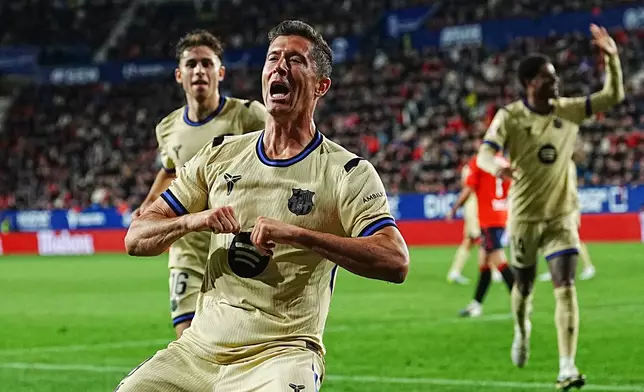 Barcelona's Robert Lewandowski celebrates after scoring his side's opening goal during a Spanish La Liga soccer match between Osasuna and Barcelona in Pamplona, Spain, Saturday, May 2, 2026. (AP Photo/Miguel Oses)