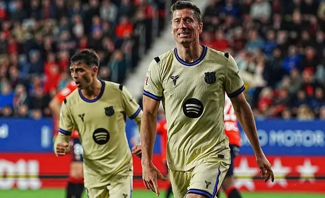 Barcelona's Robert Lewandowski celebrates after scoring his side's opening goal during a Spanish La Liga soccer match between Osasuna and Barcelona in Pamplona, Spain, Saturday, May 2, 2026. (AP Photo/Miguel Oses)