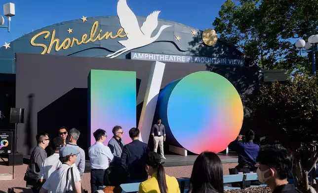 Attendees pose for photos before the keynote presentation at a Google I/O event in Mountain View, Calif., Tuesday, May 19, 2026. (AP Photo/Jeff Chiu)