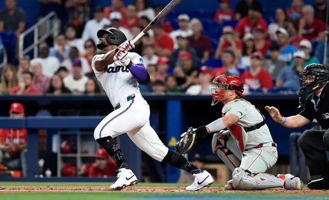 Miami Marlins' Otto Lopez flies out to right field during the first inning of a baseball game against the Philadelphia Phillies, Saturday, May 2, 2026, in Miami. (AP Photo/Michael Laughlin)