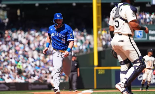 Kansas City Royals' Vinnie Pasquantino scores as Jac Caglianone hits into a force out of Michael Massey at second base as Seattle Mariners catcher Jhonny Pereda looks on during the fourth inning of a baseball game, Sunday, May 3, 2026, in Seattle. (AP Photo/Lindsey Wasson)