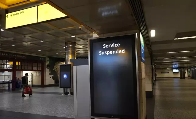 Service suspended signs are posted inside Penn Station on the first day of a Long Island Rail Road strike, Saturday, May 16, 2026, in New York. (AP Photo/Heather Khalifa)