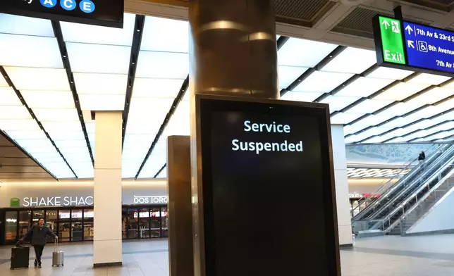 Service suspended signs are posted inside Penn Station on the first day of a Long Island Rail Road strike, Saturday, May 16, 2026, in New York. (AP Photo/Heather Khalifa)