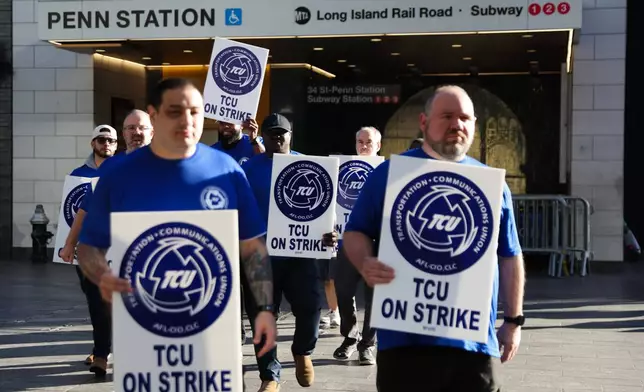 Long Island Rail Road workers walk on the picket line outside of Penn Station on the first day of their strike, Saturday, May 16, 2026, in New York. (AP Photo/Heather Khalifa)