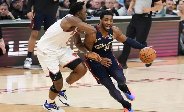 New York Knicks forward Og Anunoby (8) defense against Cleveland Cavaliers guard Donovan Mitchell (45) during the first half of Game 4 in the Eastern Conference finals NBA basketball playoffs series in Cleveland, Monday, May 25, 2026. (AP Photo/Sue Ogrocki)