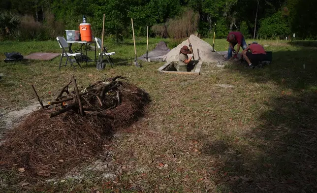 Carly Zeffren, left, with the Prairie Creek Conservation Cemetery, digs a grave with the help of volunteers Monday, April 6, 2026, in Gainesville, Fla. (AP Photo/Marta Lavandier)