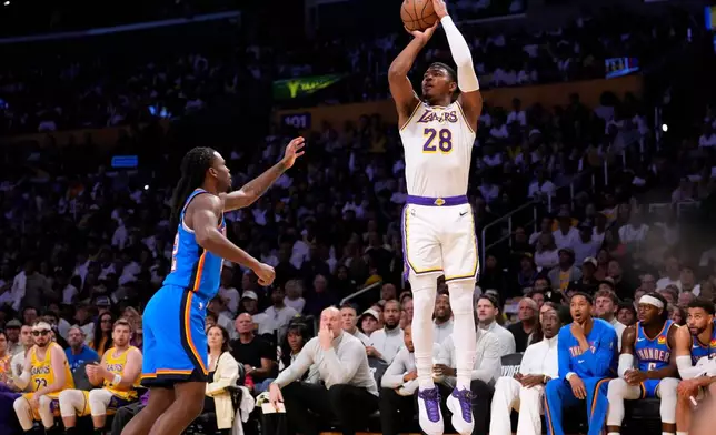 Los Angeles Lakers forward Rui Hachimura, right, shoots as Oklahoma City Thunder guard Cason Wallace defends during the first half of Game 3 in a second-round NBA basketball playoffs series Saturday, May 9, 2026, in Los Angeles. (AP Photo/Mark J. Terrill)