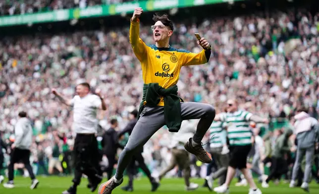 Celtic fans celebrate their side's victory over Heart of Midlothian following the Premiership soccer match between Celtic and Heart of Midlothian, in Glasgow, Scotland, Saturday May 16, 2026. (Andrew Milligan/PA via AP)