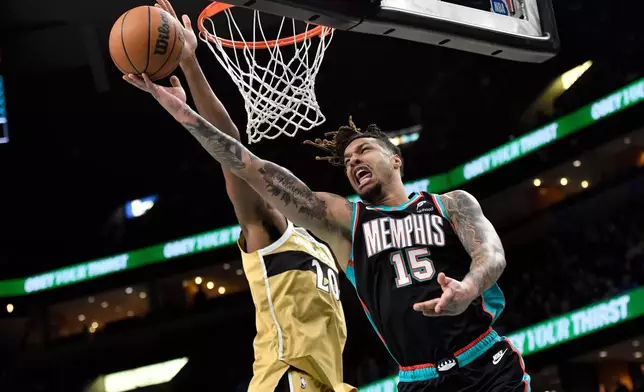 FILE - Memphis Grizzlies forward Brandon Clarke (15) shoots against Washington Wizards center Alex Sarr (20) in the first half of an NBA basketball game, Dec. 20, 2025, in Memphis, Tenn. (AP Photo/Brandon Dill)