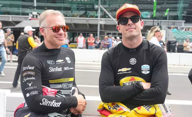 Ed Carpenter, left, talks with Scott McLaughlin before practice for the Indianapolis 500 auto race at the Indianapolis Motor Speedway in Indianapolis, Monday, May 18, 2026. (AP Photo/Michael Conroy)