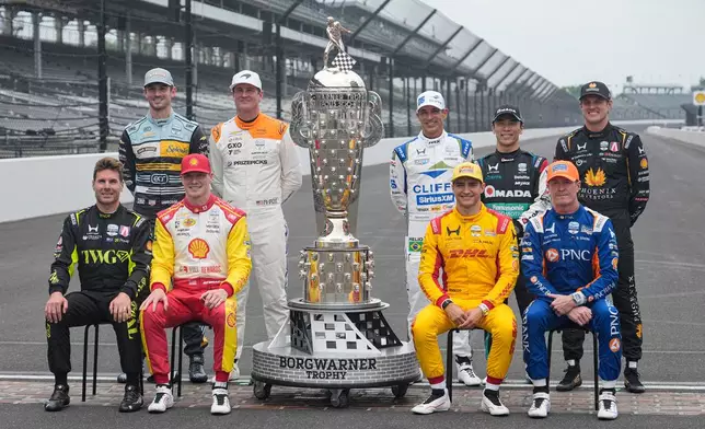 Former winners of the Indianapolis 500 auto race pose at the Indianapolis Motor Speedway in Indianapolis, Monday, May 18, 2026. Front row, left to right, Will Power, of Australia; Josef Newgarden; Alex Palou, of Spain; and Scott Dixon, of New Zealand. Second row: left to right, Alexander Rossi; Ryan Hunter-Reay; Helio Castroneves, of Brazil; Takuma Sato, of Japan; and Marcus Ericsson, of Sweden. (AP Photo/Michael Conroy)