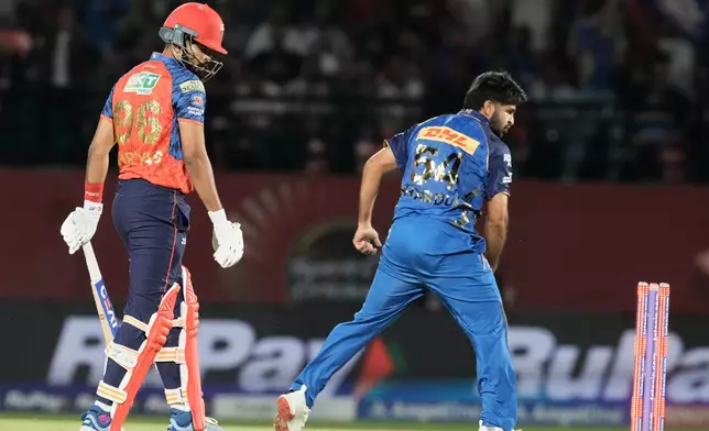 Mumbai Indians' Shardul Thakur, right, celebrates the dismissal of Punjab Kings' captain Shreyas Iyer, left, during the Indian Premier League cricket match between Punjab Kings and Mumbai Indians in Dharamshala, India, Thursday, May 14, 2026. (AP Photo/Ashwini Bhatia)