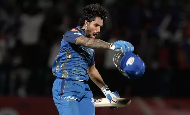 Mumbai Indians' Tilak Varma celebrates after their win in the Indian Premier League cricket match against Punjab Kings in Dharamshala, India, Thursday, May 14, 2026. (AP Photo/Ashwini Bhatia)