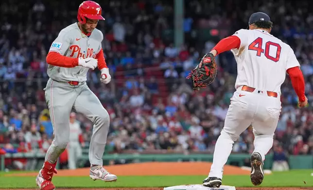 Boston Red Sox first baseman Willson Contreras (40) makes the force out, after making the play on a grounder by Philadelphia Phillies' Justin Crawford, left, during the fifth inning of a baseball game, Wednesday, May 13, 2026, in Boston. (AP Photo/Charles Krupa)