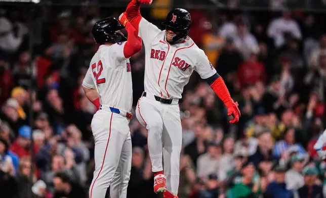 Boston Red Sox's Ceddanne Rafaela, right, celebrates with Wilyer Abreu after his two-run home run during the sixth inning of a baseball game against the Philadelphia Phillies, Wednesday, May 13, 2026, in Boston. (AP Photo/Charles Krupa)