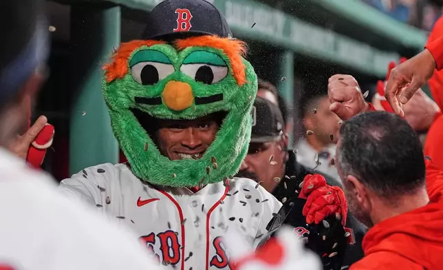 Boston Red Sox's Ceddanne Rafaela is doused with sunflower seeds while celebrating after his two-run home run during the sixth inning of a baseball game against the Philadelphia Phillies, Wednesday, May 13, 2026, in Boston. (AP Photo/Charles Krupa)