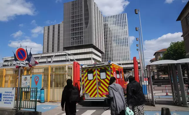 An ambulance enters the Bichat Hospital where a woman who tested positive for hantavirus remains in intensive care, in Paris, Tuesday, May 12, 2026. (AP Photo/Michel Euler)