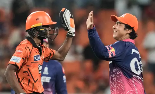Sunrisers Hyderabad's Sakib Hussain, left, and Rajasthan Royals' Vaibhav Sooryavanshi share a light moment during the Indian Premier League cricket match between Rajasthan Royals and Sunrisers Hyderabad in New Chandigarh, India, Wednesday, May 27, 2026. (AP Photo/Ashwini Bhatia)