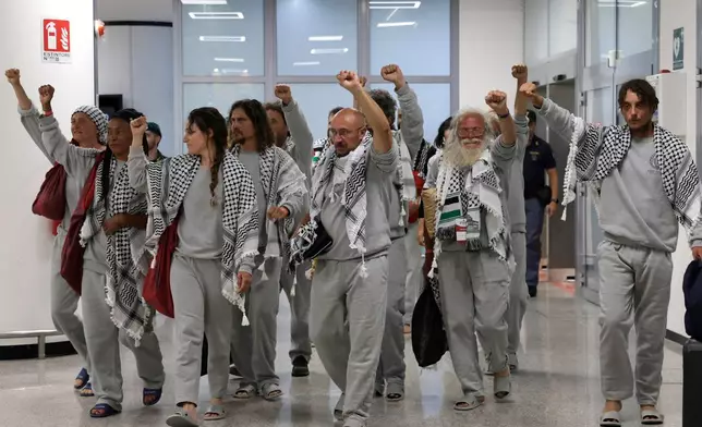 Italian members of the Global Sumud Flotilla arrive at the Fiumicino Airport in Rome on Thursday, May 21, 2026, after they were released and deported by the Israeli government after attempting to reach Gaza. (Cecilia Fabiano/LaPresse via AP)
