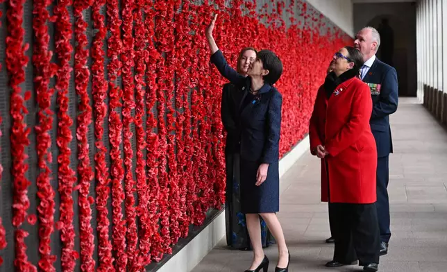 Japan's Prime Minister Sanae Takaichi, secind left, walks along the Roll of Honour during a visit to the Australian War Memorial in Canberra, Australia, Monday, May 4, 2026. (Lukas Coch/AAP Image via AP)