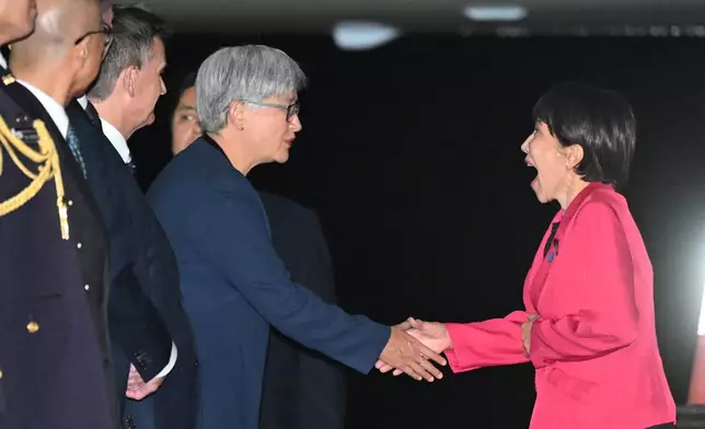 Prime Minister of Japan Sanae Takaichi, right, is greeted by Australian Foreign Minister Penny Wong in Canberra, Australia, Sunday, May 3, 2026. (Lukas Coch/AAP Image via AP)