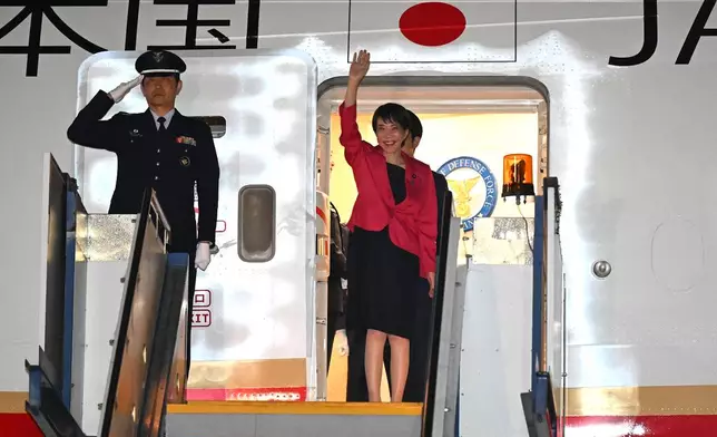 Prime Minister of Japan Sanae Takaichi, right, waves as she arrives in Canberra, Australia, Sunday, May 3, 2026. (Lukas Coch/AAP Image via AP)