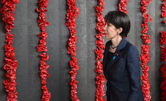 Japan's Prime Minister Sanae Takaichi walks along the Roll of Honour during a visit to the Australian War Memorial in Canberra, Australia, Monday, May 4, 2026. (Lukas Coch/AAP Image via AP)