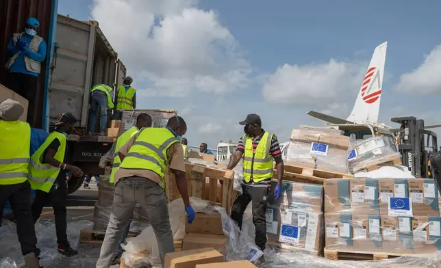 Workers offload medical and emergency supplies donated by European Union to support frontline workers in fighting Ebola upon arrival at the national airport in Bunia, Congo. Thursday, May 28, 2026. (AP Photo/Moses Sawasawa)