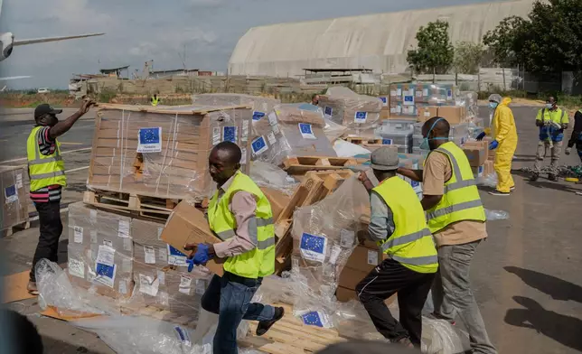 Workers offload medical and emergency supplies donated by European Union to support frontline workers in fighting Ebola upon arrival at the national airport in Bunia, Congo. Thursday, May 28, 2026. (AP Photo/Moses Sawasawa)