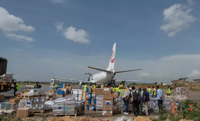 Workers offload medical and emergency supplies donated by European Union to support frontline workers in fighting Ebola upon arrival at the national airport in Bunia , Congo. Thursday, May 28, 2026. (AP Photo/Moses Sawasawa)