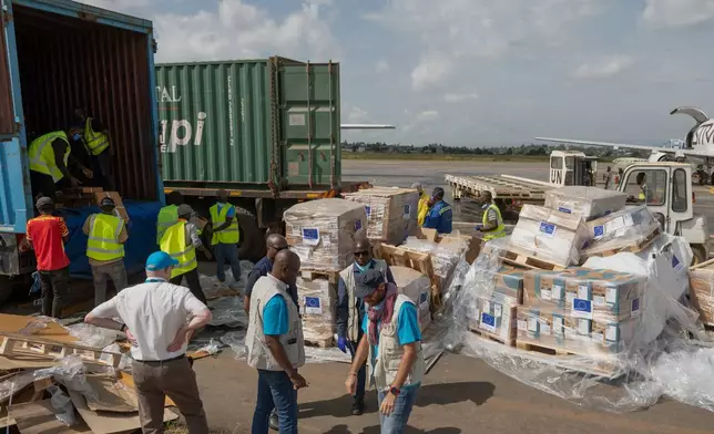 Workers offload medical and emergency supplies donated by European Union to support frontline workers in fighting Ebola upon arrival at the national airport in Bunia , Congo. Thursday, May 28, 2026. (AP Photo/Moses Sawasawa)