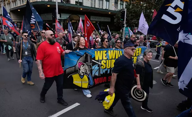 People march to mark International Workers' Day, also known as May Day, in Sydney, Friday, May 1, 2026. (AP Photo/Rick Rycroft)
