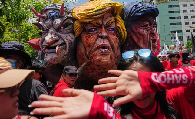 Protesters push an effigy of, from left, Israel Prime Minister Benjamin Netanyahu, U.S. President Donald Trump and Philippine President Ferdinand Marcos Jr. during a May Day rally in Manila, Philippines on Friday, May 1, 2026. (AP Photo/Aaron Favila)