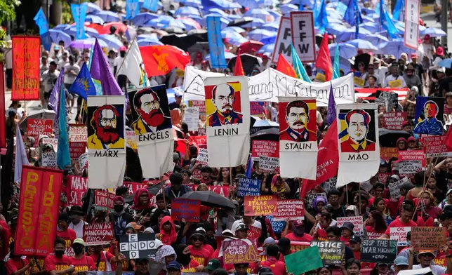 Protesters hold posters of communist figures as they march towards the Malacanang presidential palace during a May Day rally in Manila, Philippines on Friday, May 1, 2026. (AP Photo/Aaron Favila)