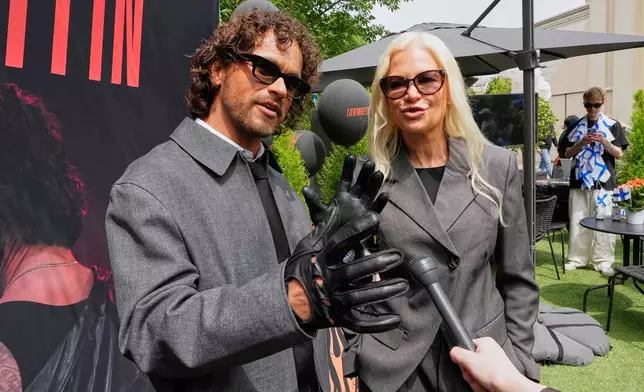 Linda Lampenius and Pete Parkkonen, who compete as Liekinheitin for Finland at the 70th Eurovision Song Contest, talk during an interview with The Associated Press in Vienna, Austria, Thursday, May 14, 2026. (AP Photo/Martin Meissner)