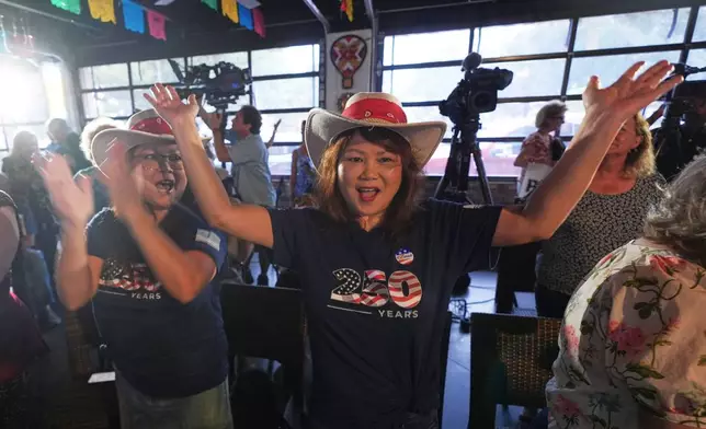 Melinda Tran, right, and Mimi Liter cheer after an endorsement announcement for Texas Attorney General Ken Paxton, a Republican candidate for the U.S. Senate, at a campaign event in McKinney, Texas, Tuesday, May 19, 2026. (AP Photo/LM Otero)
