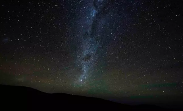 FILE - The Milky Way stretches across the night sky as seen from the Atacama Desert, Chile, Wednesday, April 15, 2026. (AP Photo/Esteban Felix, File)