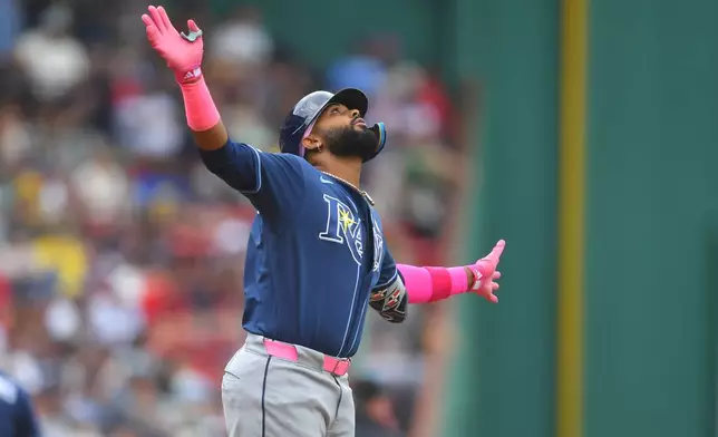 Tampa Bay Rays' Junior Caminero celebrates after his home run as he arrives at home plate in the first inning of a baseball game against the Boston Red Sox, Sunday, May 10, 2026, in Boston. (AP Photo/Steven Senne)