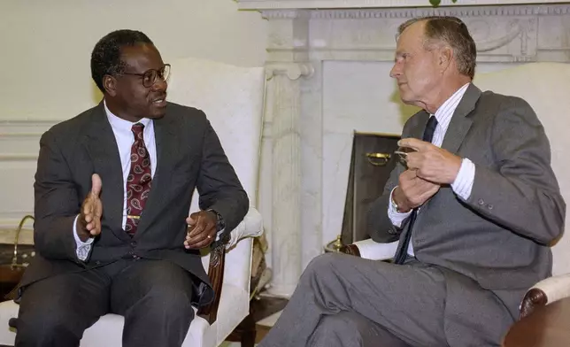 FILE - President George H.W. Bush and Supreme Court nominee Clarence Thomas hold a private meeting in the Oval Office at the White House in Washington, Sept. 6, 1991. (AP Photo/Greg Gibson, File)